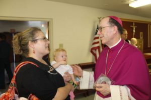 Bishop Olmsted visits with parishioners at Mater Misericordiae after a June 13 prayer service. 