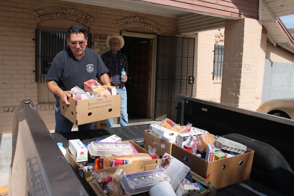 Bobby Hernandez, a volunteer with the Society of St. Vincent de Paul, loads the last food box he is delivering to those in need in the area surrounding St. Matthew Parish in Phoenix. St. Vincent de Paul pantries across the Diocese of Phoenix often empty out in the summer months as demand increases and supply decreases. (Ambria Hammel/CATHOLIC SUN)