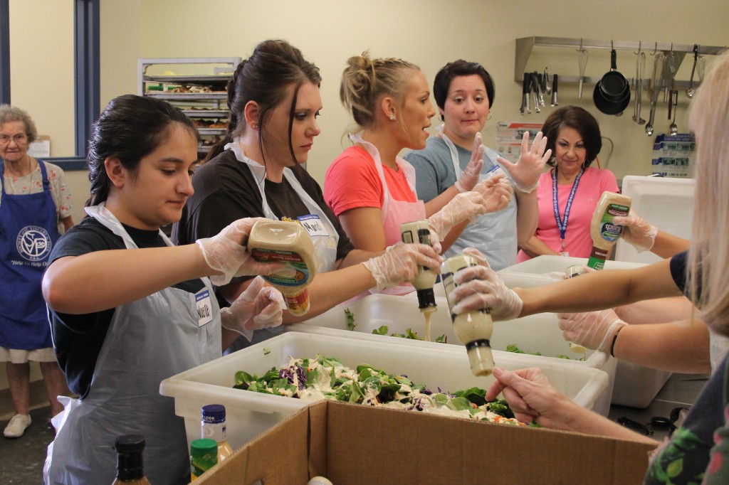 Volunteers from St. Clare of Assisi in Surprise and Grace Mennonite Church in Ohio prepare lunch at the Henry Unger Memorial Dining Room June 2. All five St. Vincent de Paul dining rooms regularly host church and community groups plus corporate teams eager serve to some 3,500 meals per day to clients who otherwise would go hungry. (Ambria Hammel/CATHOLIC SUN)