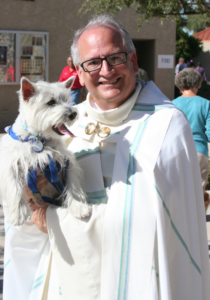 Fr. Thomas Hallsten, pastor of Holy Spirit Parish, holds Roni during a pet blessing ceremony in 2009. 