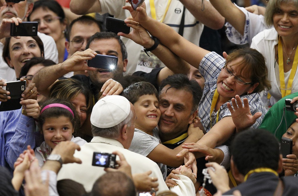 Pope Francis greets people as he arrives to open the annual convention of the Diocese of Rome in Paul VI hall at the Vatican June 16. In his talk, the pope responded to concerns about the difficulties of keeping families active in parish life. (CNS photo/Paul Haring)
