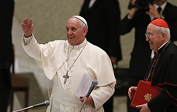 Pope Francis waves as he leaves after opening the annual convention of the Diocese of Rome in Paul VI hall at the Vatican June 16. In his talk, the pope responded to concerns about the difficulties of keeping families active in parish life. Also pictured is Cardinal Agostino Vallini, papal vicar for Rome. (CNS photo/Paul Haring)