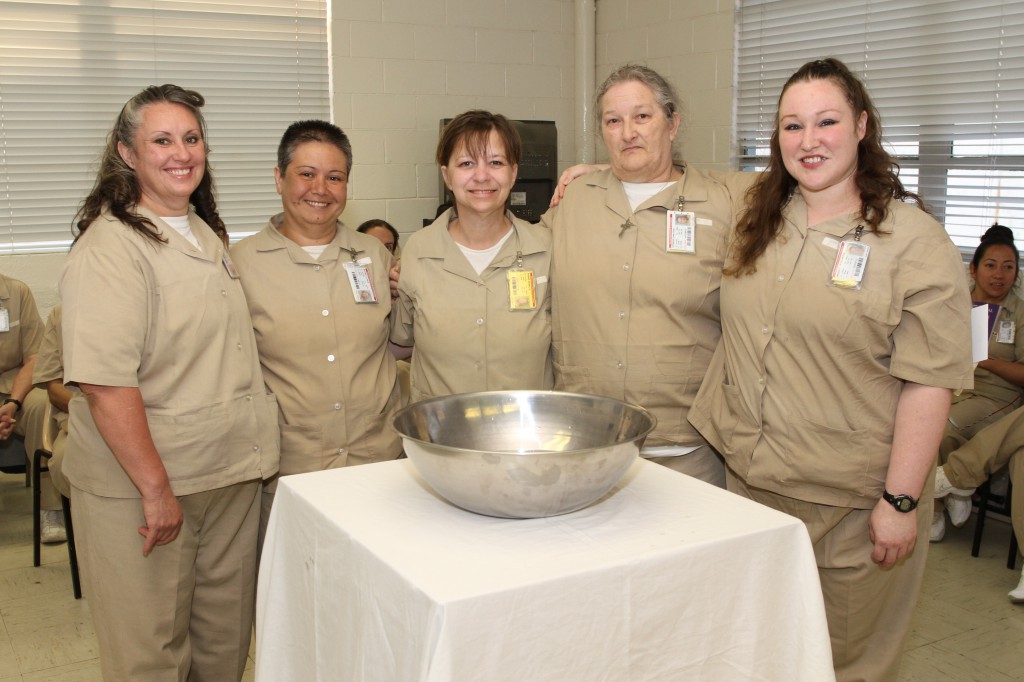 State prisoners at Lee Arrendale State Prison in Alto, Ga., pose for a photo after Mass during which several inmates were baptized and confirmed. For many prisoners attending the evening Mass, the encounter with the Catholic Church is their only contact with the outside world. Standing in the photo are Melissa Deal, Alma B. Mitchell, Beverly Dawn Barber, Carla Rae Hopwood and Felicia Nicole Greenway. (CNS photo/Michael Alexander, Georgia Bulletin)
