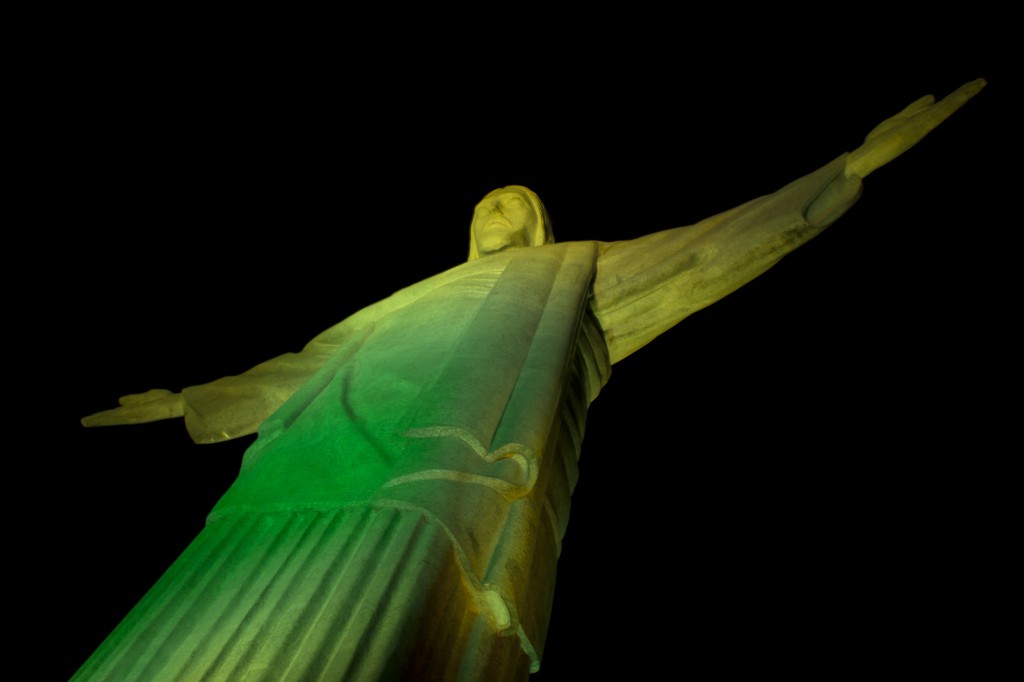 Rio's Christ the Redeemer Statue glows green to help kickoff the 2014 FIFA World Cup. (CNS photo/Daniel Coelho, RIOLUZ) 