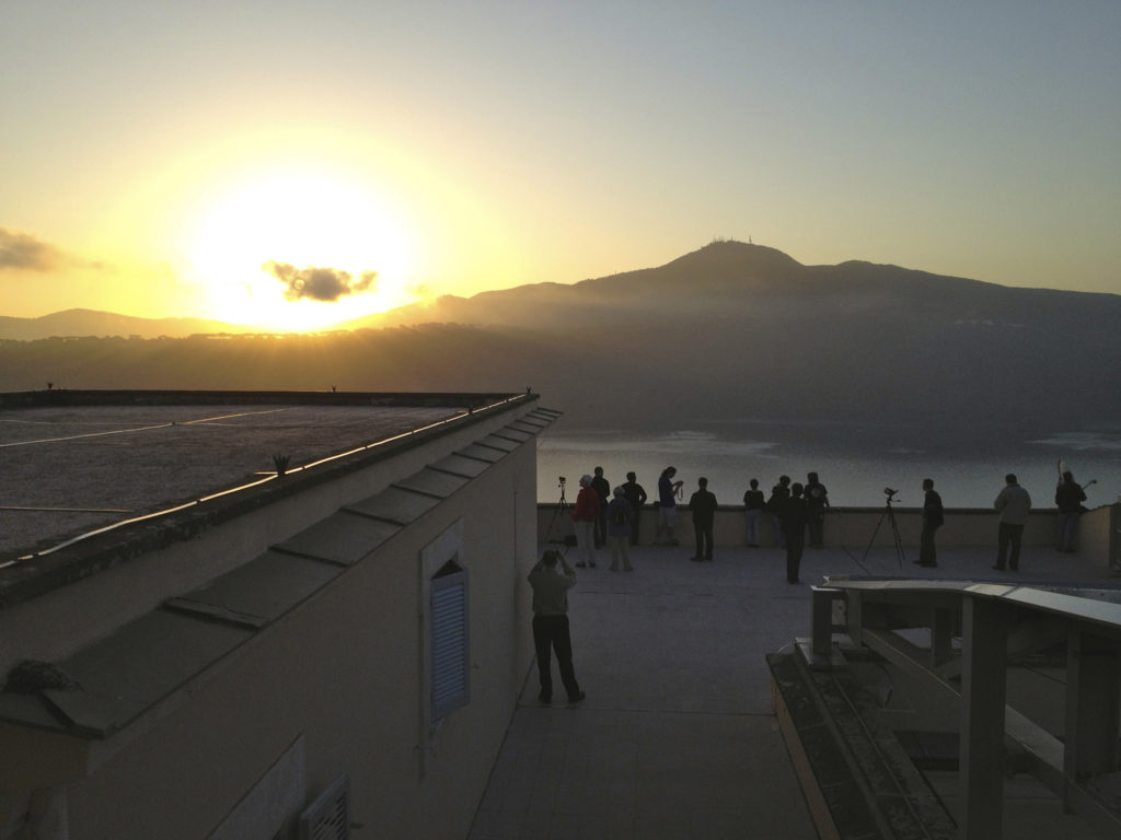 An international group of students observe the transit of Venus at sunrise from the roof of the papal summer villa in Castel Gandolfo, Italy, June 6, 2012. The students attending a Vatican Observatory summer school watched the rare occurrence of the planet Venus crossing the face of the sun. (CNS file photo/Jesuit Brother Guy Consolmagno, Specola Vaticana)