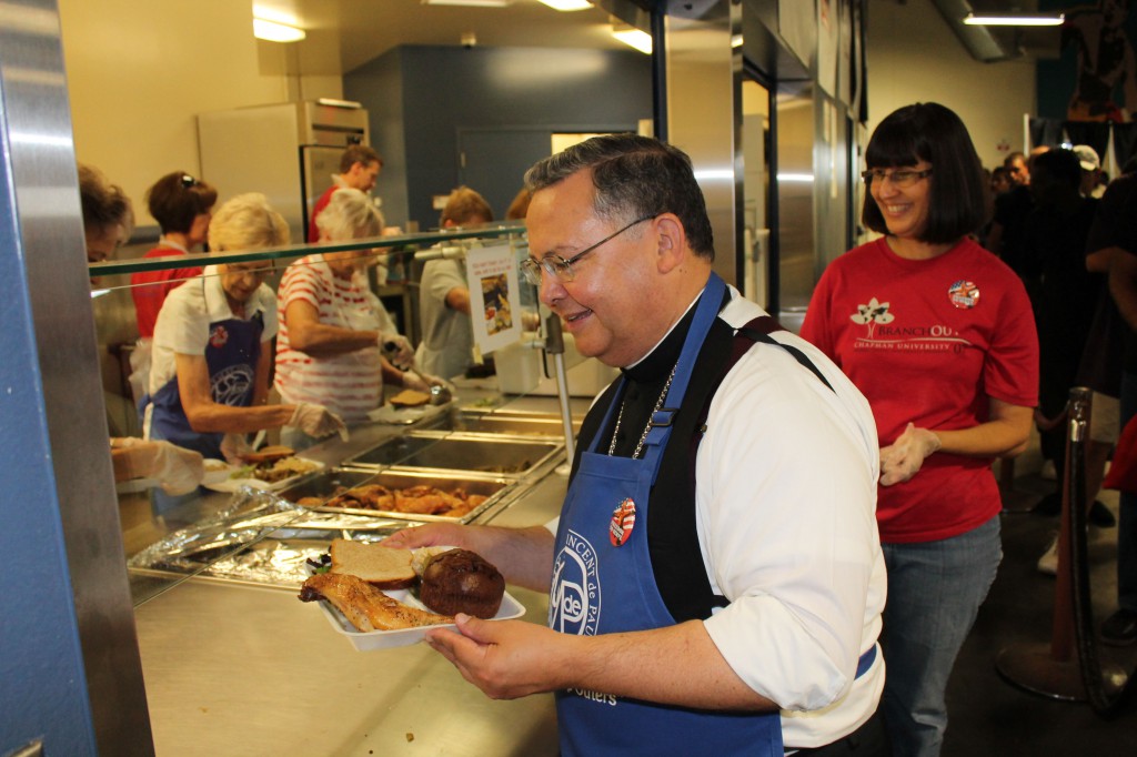 The St. Vincent de Paul Society dining rooms serve over 1.2 million meals to the hungry every year. Auxiliary Bishop Eduardo A. Nevares was on hand with other volunteers from the Diocese of Phoenix to serve at the Henry Unger Memorial Dining Room in downtown Phoenix July 4. (Joyce Coronel/CATHOLIC SUN)