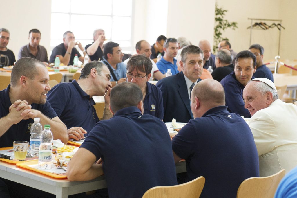Pope Francis talks with Vatican workers during a surprise visit to the Vatican cafeteria July 25. (CNS photo/L'Osservatore Romano via Reuters)