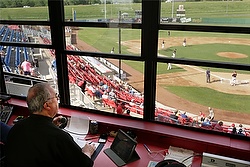 Fr. Craig Collison, a priest in the Diocese of Sioux City, Iowa, watches baseball action from the announcer's booth June 4 as the Sioux City Explorers play the Gary, Ind., Southshore Railcats. Fr. Collison, a play-by-play announcer for the minor league team, loves baseball and says being at the ballpark in a priest's collar gives him an opportunity to evangelize. (CNS photo/Jerry L. Mennenga, Catholic Globe) 
