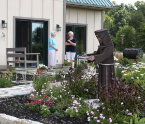 St. Francis Sister Jane Frances Omler, right, and St. Francis Sister Jacqueline Doepker talk on the patio of the energy-efficient straw-bale house they helped build in Tiffin, Ohio in a July photo. The Sisters of St. Francis of Tiffin built the house as a demonstration project to show that by incorporating non-traditional materials and a renewable-energy system, a house -- or almost any structure -- can be comfortable and good for the environment. (CNS photo/Chaz Muth)
