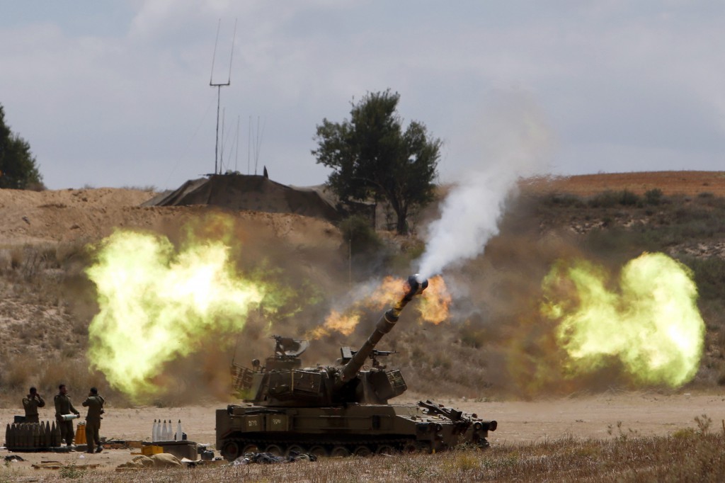 An Israeli mobile artillery unit fires toward the Gaza Strip July 18. Pope Francis telephoned Israeli President Shimon Peres and Palestinian President Mahmoud Abbas July 18, urging all sides to end hostilities and build peace. (CNS photo/Nir Elias, Reuters) 