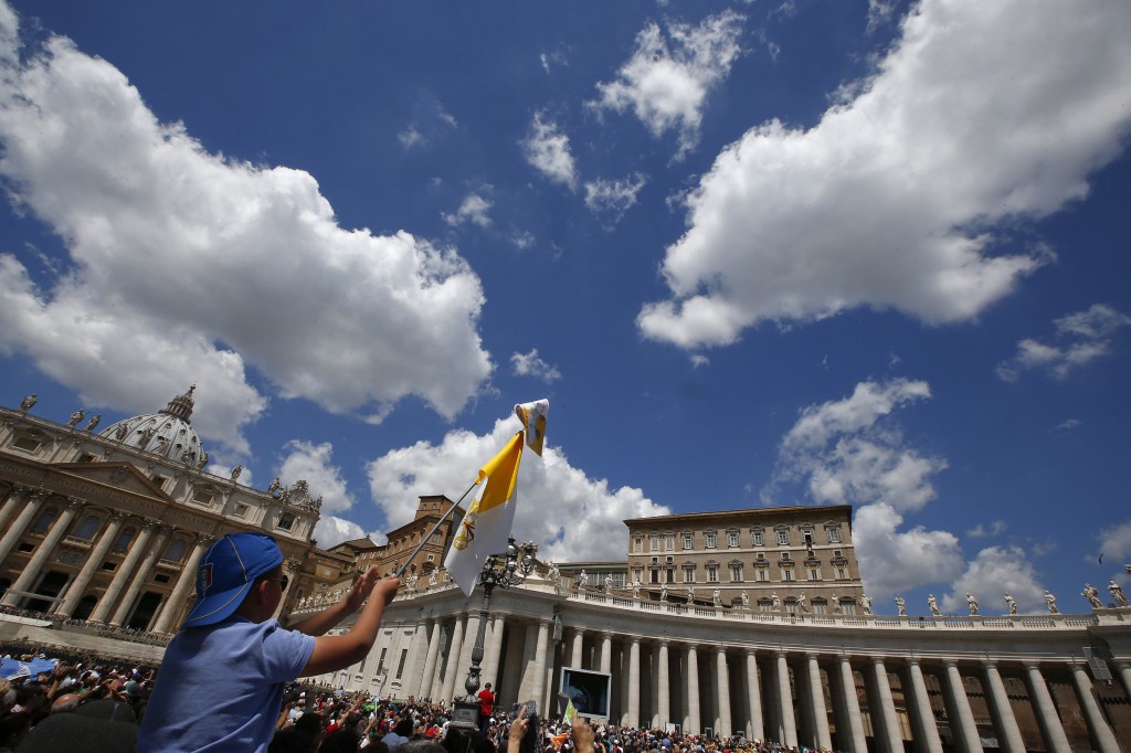 A child waves a flag as Pope Francis leads his Sunday Angelus in St. Peter's Square at the Vatican May 18. (CNS photo/Tony Gentile, Reuters)
