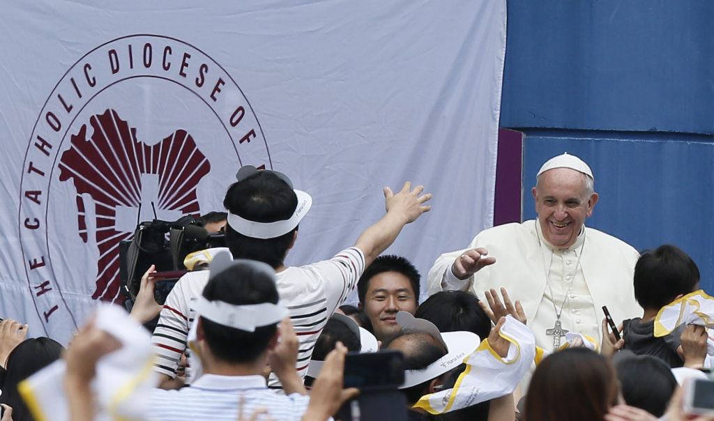 Pope Francis greets the crowd as he arrives to celebrate Mass on the feast of the Assumption in World Cup Stadium in Daejeon, South Korea, Aug. 15. (CNS photo/Paul Haring)
