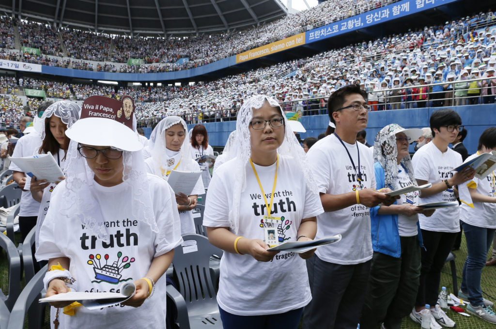 Survivors and relatives of victims of the April South Korean ferry accident attend Pope Francis' celebration of Mass on the feast of the Assumption in World Cup Stadium in Daejeon, South Korea, Aug. 15. (CNS photo/Paul Haring)