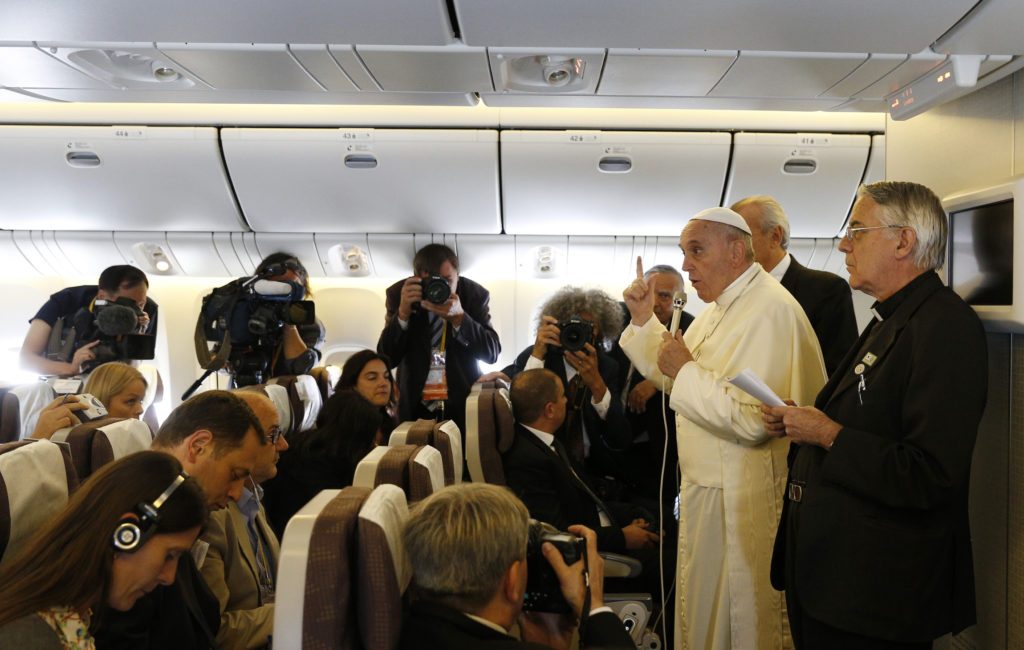 Pope Francis answers questions from journalists aboard the papal flight from Seoul, South Korea, to Rome Aug. 18. (CNS photo/Paul Haring)