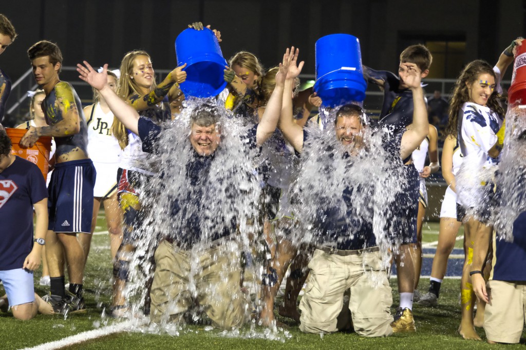 Fausin Weber, headmaster, left, and Deacon Brian Edwards, chair of the theology department at Pope John Paul II High School in Hendersonville, Tenn., were doused with ice water in the ALS "Ice Bucket Challenge" at half time at the school's Aug. 22 football game. Proceeds were donated to the John Paul II Medical Research Institute in Iowa City, Iowa, which sponsors ALS research without using embryonic stem cells. (CNS photo/Rick Musacchio, Tennessee Register)
