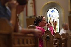 A woman prays during Mass at St. Mary's Basilica in Phoenix Aug. 15. (CNS photo/Nancy Wiechec)