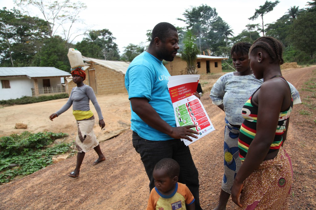 A man in Lofa, Liberia, educates villagers in late April on the prevention of Ebola disease. A Catholic priest from Sierra Leone asked for prayers for West African countries affected by Ebola. (CNS photo/Ahmed Jallanzo, EPA)  