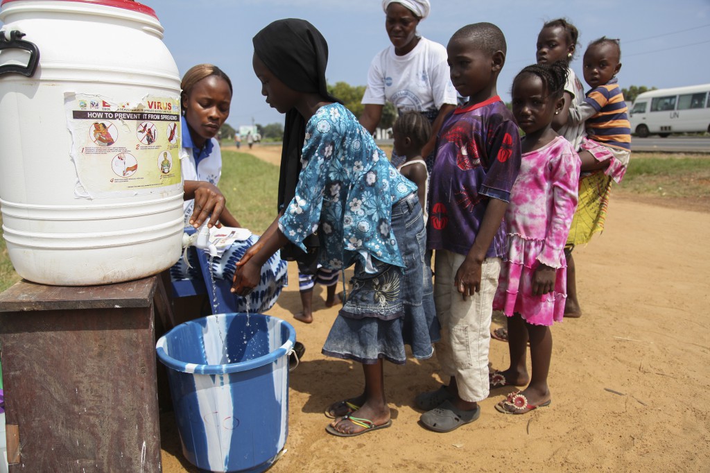 Liberian children are encouraged to wash their hands as part of an Ebola sensitization program in Monrovia, Liberia, Aug. 5. The death toll from the Ebola outbreak in Guinea, Liberia and Sierra Leone has risen to at least 932, the World Health Organization said Aug. 6. (CNS photo/Ahmed Jallanzo, EPA)  