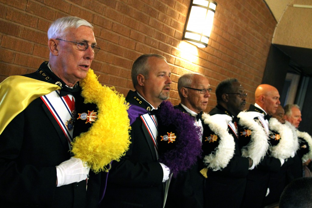 Known for their devotion to and respect for the Eucharist, Knights in full regalia stand at attention, hats removed, at the June 28 ordination of three men to the priesthood at Ss. Simon and Jude Cathedral. (Ambria Hammel/CATHOLIC SUN)