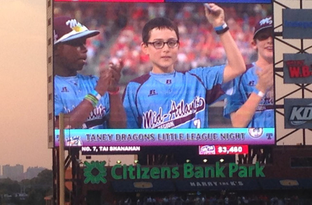 Tai Shanahan tips his cap as he is introduced along with his Taney Dragons Little League teammates at a special ceremony Aug. 27 at Philadelphia's Citizens Bank Park before the Phillies-Nationals game. The 13-year-old altar server at Philadelphia's St. Francis de Sales Parish was being honored because his team played in the Little League World Series. (CNS photo/John Knebels, CatholicPhilly.com)  