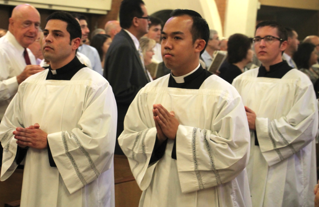 Vinhson Nguyen, center, is pictured during the 2014 priestly ordination at Ss. Simon and Jude. Nguyen is now studying in Rome and just wrapped up orientation week. (Ambria Hammel/CATHOLIC SUN)