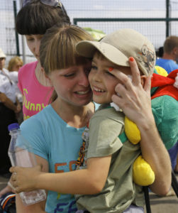 A Ukrainian woman weeps after being reunited with her son at the Russia-Ukraine border in Russia's Rostov region Aug. 22. Ukrainians mark Independence Day Aug. 24 amid ongoing tensions in the East. (CNS photo/Alexander Demianchuk, Reuters) 
