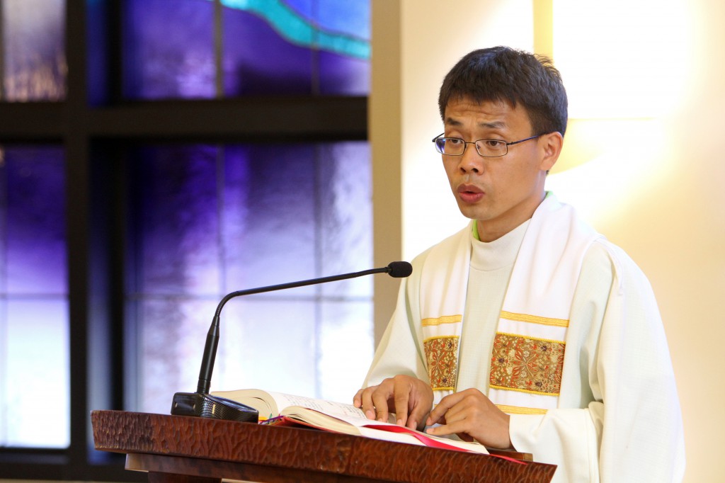 Fr. Joseph Su Xin of the Diocese of Baoding, China, proclaims the Gospel during Mass at the Cenacle Retreat Center in Ronkonkoma, N.Y., Aug. 20. Father Su, a participant in Maryknoll's Chinese Seminary Teachers and Formators Project, is pursuing a master's degree in spiritual direction at Fordham University in New York. (CNS photo/Gregory A. Shemitz)