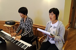 Chinese Sisters Jean Qi Zhi Zhen, left, a member of the Sisters of St. Theresa of the Child Jesus, and Paulina Feng Shuang, a member of the Fushun Sisters of the Sacred Heart of Jesus, lead the music during an Aug. 20 Mass  affiliated with Maryknoll's Chinese Seminary Teachers and Formators Project. (CNS photo/Gregory A. Shemitz) 