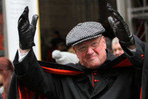 Cardinal Timothy M. Dolan of New York waves to marchers while reviewing the St. Patrick's Day Parade in New York March 17. Cardinal Dolan, who will be the grand marshal of next year's parade, said he continues to support the parade committee after it lifted a ban prohibiting gay, lesbian, bisexual and transgender groups from marching openly in the annual event. (CNS photo/Gregory A. Shemitz)