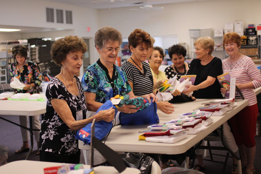 Members of the Christ Child Society, pictured here Sept. 4, prepare nearly 800 “bedtime bags” for children in crisis each year. They always try to include a coloring book or storybook along with a handmade teddy bear. (Joyce Coronel/CATHOLIC SUN)