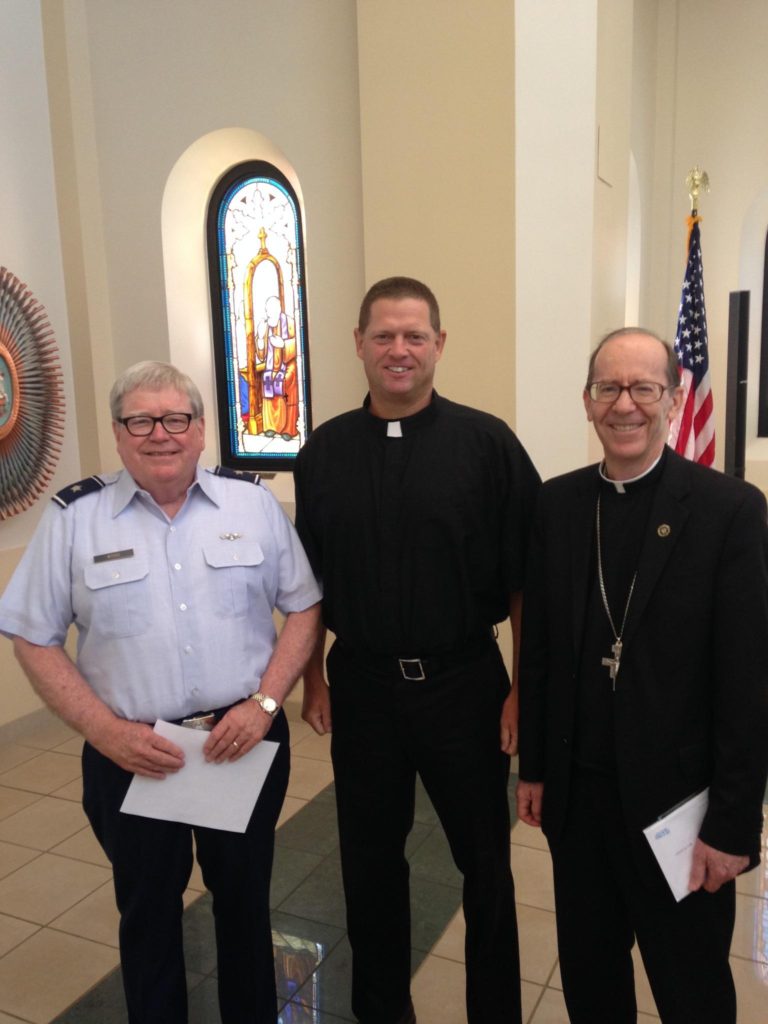 Fr. Craig Friedley, center, was sworn in as chaplain for the Army National Guard. (courtesy photo)