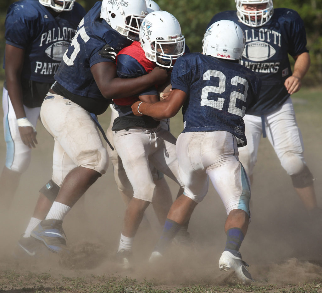 Players converge on the quarterback during football practice at St. Vincent Pallotti High School in Laurel, Md. in this 2013 file photo.  (CNS photo/Bob Roller)