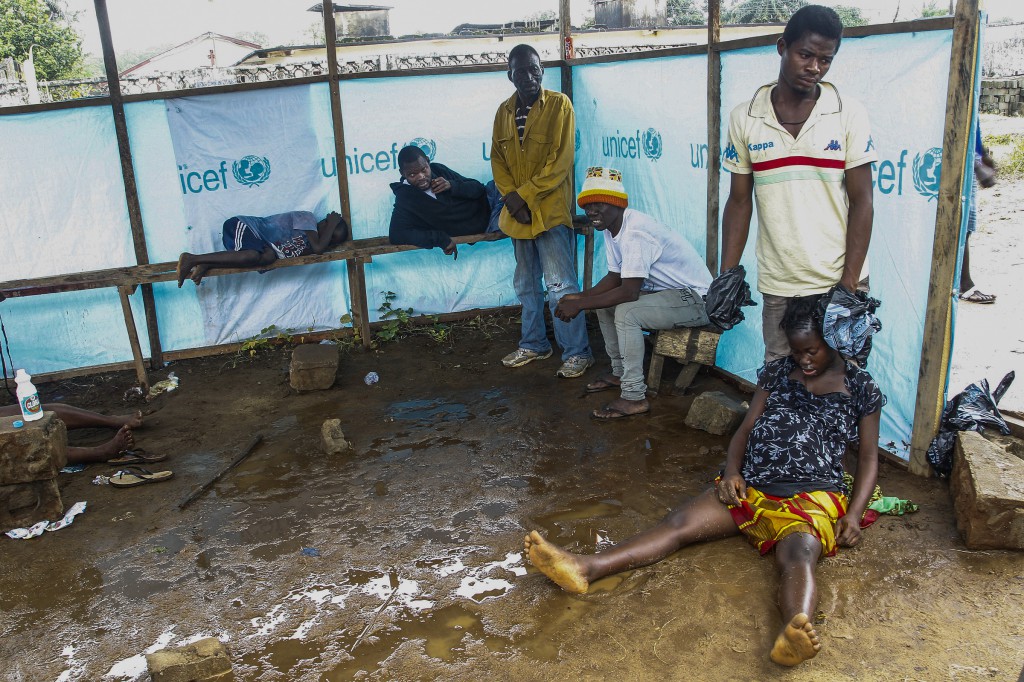 Liberians wait outside the John F. Kennedy Ebola treatment center in Monrovia, Liberia, Sept. 18. Pope Francis called for prayers and concrete help for the thousands of people affected by the deadly Ebola virus. (CNS photo/Ahmed Jallanzo, EPA) 
