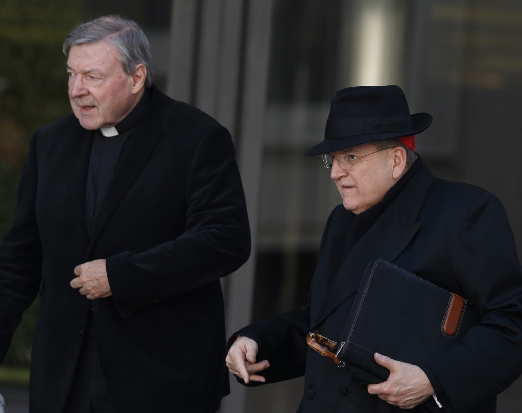 Australian Cardinal George Pell and U.S. Cardinal Raymond L. Burke leave a meeting of Pope Francis and cardinals in the synod hall at the Vatican in this Feb. 21 file photo. Both cardinals oppose proposed changes to church practice that would allow divorced and civilly remarried Catholics to receive Communion. (CNS photo/Paul Haring)