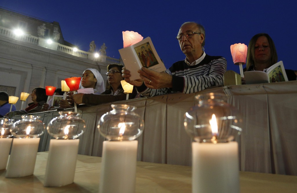 People attend an Oct. 4 prayer vigil led by Pope Francis for the extraordinary Synod of Bishops on the family in St. Peter's Square at the Vatican. The pope called for "sincere, open and fraternal" debate during the two-week long synod, which opens Oct. 5. (CNS photo/Paul Haring)