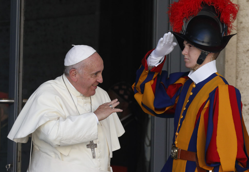 A Swiss Guard salutes as Pope Francis leaves the opening session of the extraordinary Synod of Bishops on the family at the Vatican Oct. 6. (CNS photoPaul Haring)