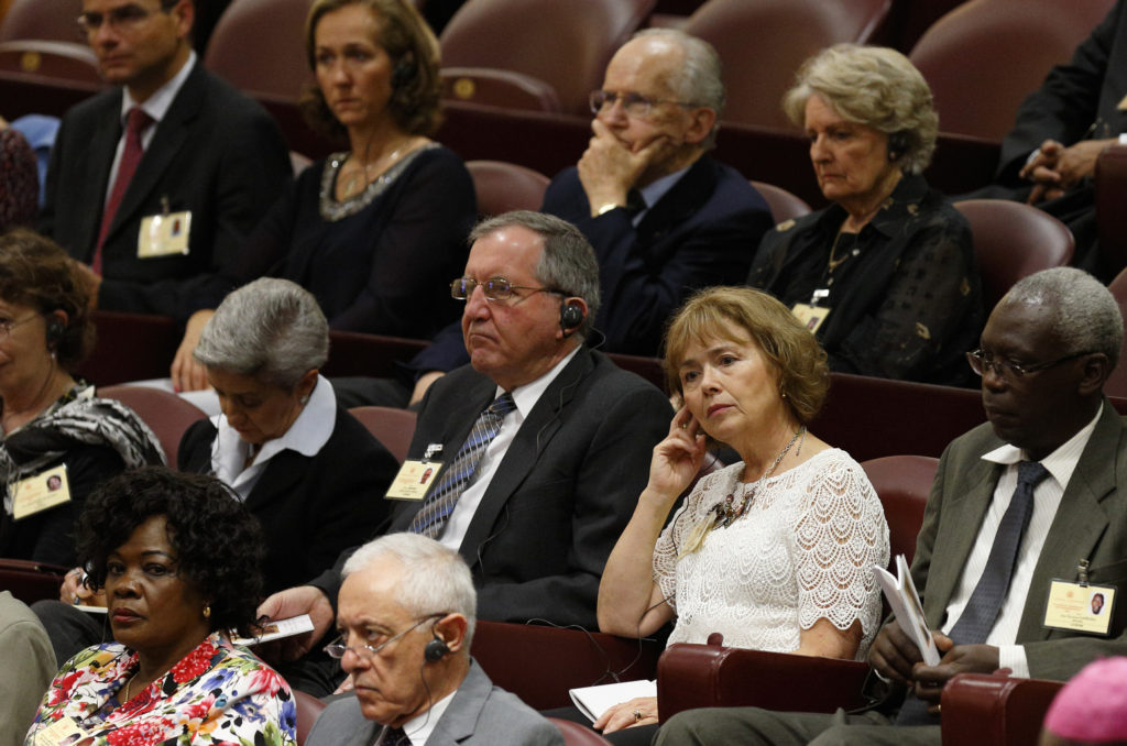 Alice and Jeff Heinzen of Menomonie, Wis., center, sit among other auditors as they attend the morning session of the extraordinary Synod of Bishops on the family at the Vatican Oct. 9. (CNS photo/Paul Haring)