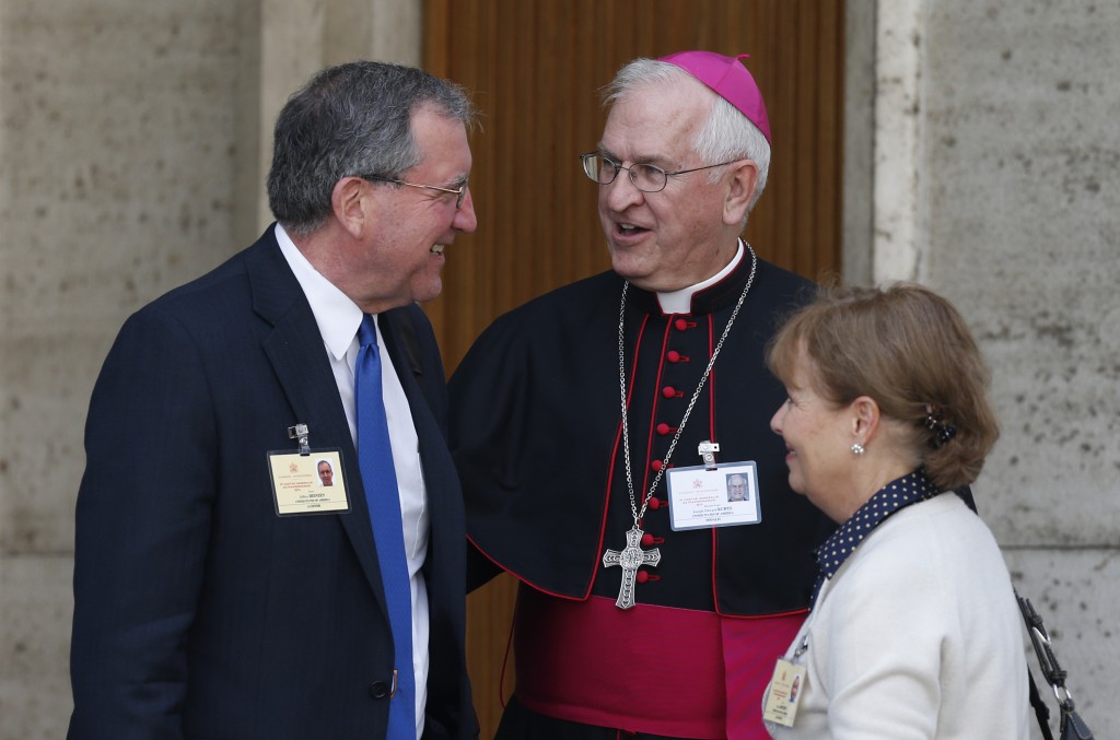 Archbishop Joseph E. Kurtz of Louisville, Ky., president of the U.S. Conference of Catholic Bishops, talks with Jeff and Alice Heinzen of Menomonie, Wis., as they leave the morning session of the extraordinary Synod of Bishops on the family at the Vatican Oct. 13. The couple are auditors at the synod. (CNS photo/Paul Haring)