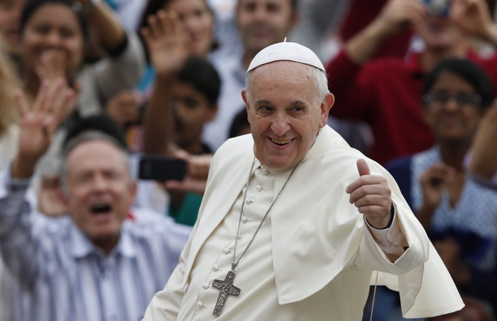 Pope Francis gives a thumbs up as he greets the crowd during his general audience in St. Peter's Square at the Vatican Oct. 15. (CNS photo/Paul Haring)