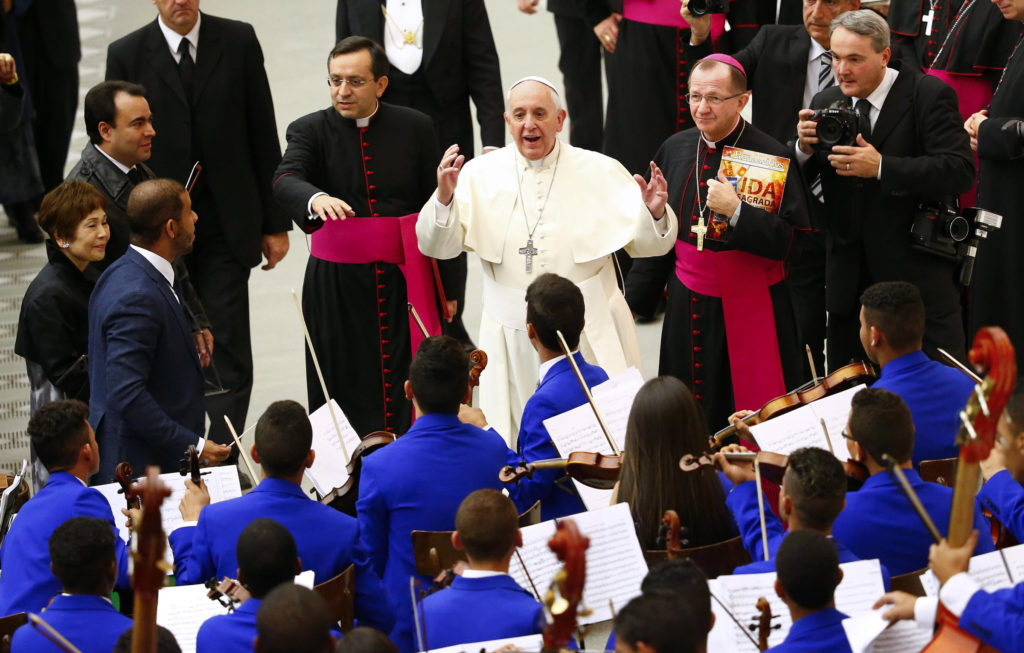 Pope Francis talks to members of an orchestra during a special audience with members of the Catholic Fraternity of Charismatic Covenant Communities and Fellowships at the Vatican Oct. 31. The pope met with about 1,000 charismatic Catholics and their Protestant guests who were participating in a conference about the charismatic movement and new evangelization. (CNS photo/Tony Gentile, Reuters)