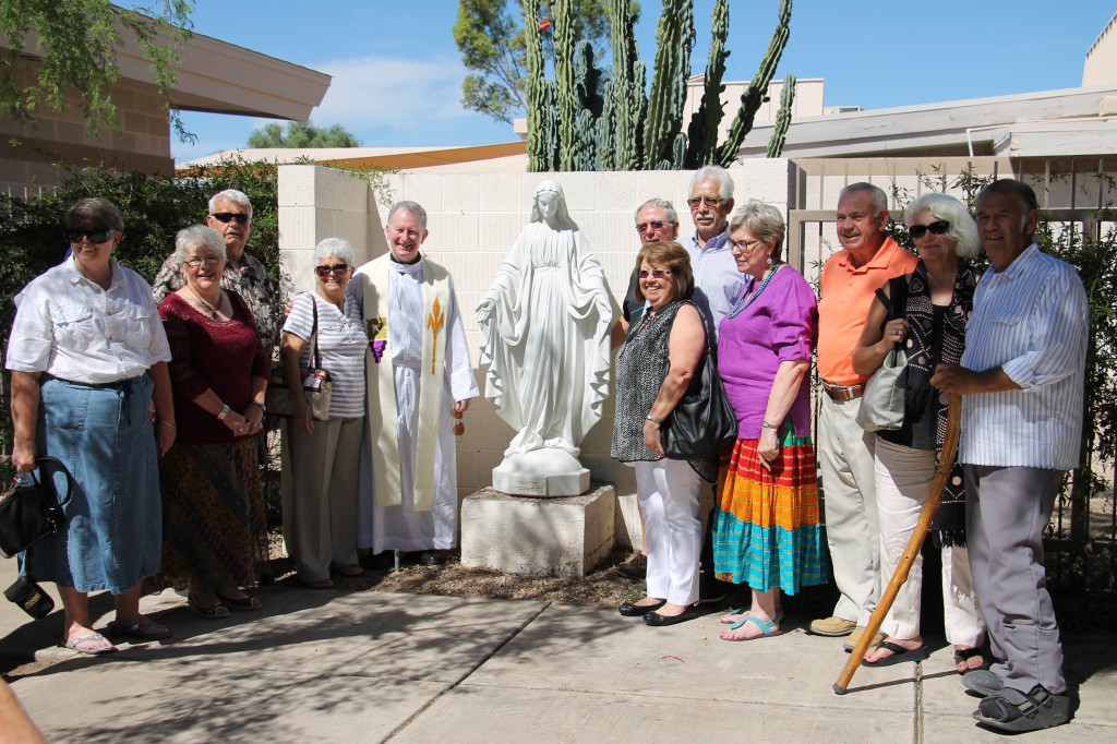 Several members of the Class of 1958, including Msgr. ____, gather around a restored Madonna statute in Seton Catholic Preparatory's alumni courtyard Oct. 4 following a re-dedication in honor of the school's 60th anniversary (Ambria Hammel/CATHOLIC SUN) 