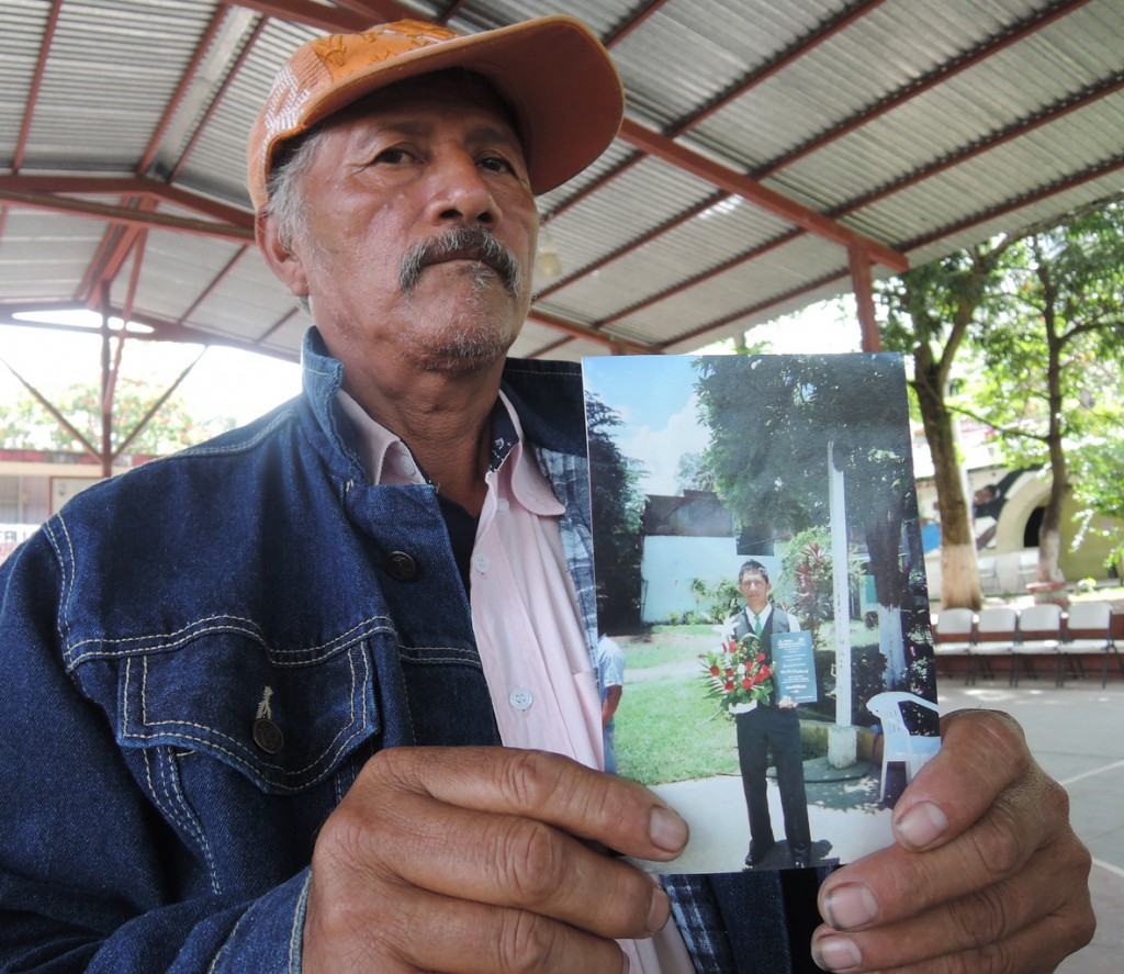 Margarito Ramirez shows a picture of his 20-year-old son, Carlos Ivan Ramirez Villarreal, Oct. 8, who was among the 43 students missing in Mexico's Guerrero state. The Sept. 26 disappearance of so many students in Guerrero states has sparked international outrage and soul searching among many Mexicans. (CNS photo/David Agren)  