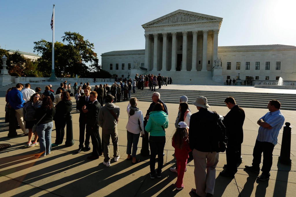 Visitors stand in line for oral arguments on the first day of the term of the U.S. Supreme Court in Washington Oct. 6. Rulings that overturned state bans on same-sex marriage in five states will be allowed to take effect, after the court declined to consider appeals of lower court rulings that such prohibitions are unconstitutional. (CNS photo/Jonathan Ernst, Reuters) 