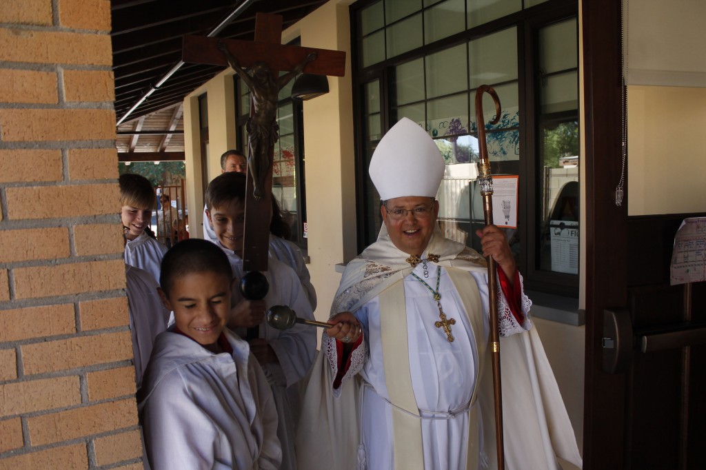 The sprinkling of holy water sanctified the St. Theresa Little Flower Early Childhood Center — and a few of the altar servers who processed through the building with Auxiliary Bishop Nevares at the blessing ceremony Oct. 1. (Joyce Coronel/Catholic Sun)