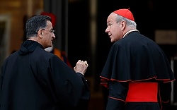 Lebanese Cardinal Bechara Rai, patriarch of the Maronite Catholic Church, talks with Austrian Cardinal Christoph Schonborn of Vienna as they arrive for the morning session of the extraordinary Synod of Bishops on the family at the Vatican Oct. 16. Cardinal Schonborn said it's a perennial challenge for the Catholic Church to unite doctrine and mercy. (CNS photo/Paul Haring) 
