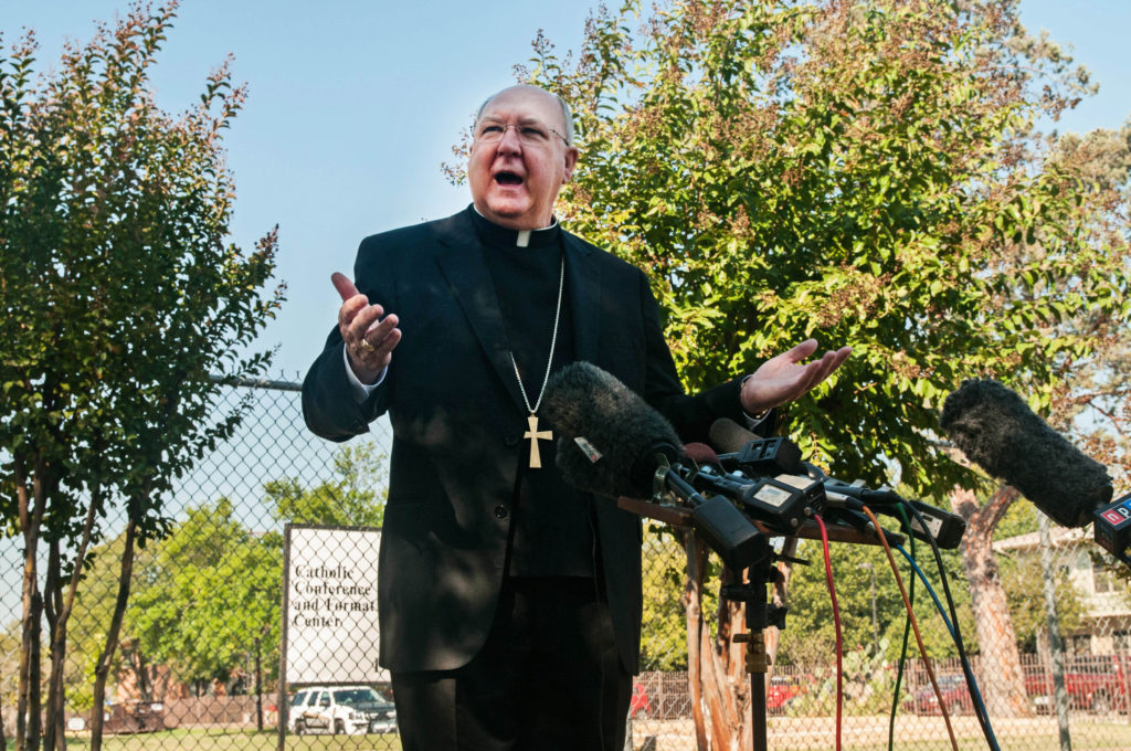 Dallas Bishop Kevin J. Farrell answers questions from media Oct. 20 about what will happen to the diocese's building in South Dallas where Ebola victim Thomas Duncan's financee and her family were quarantined. The bishop's news conference coincided with the lifting of the 21-day quarantine for nearly four dozen people being screened for the Ebola virus, with none showing any signs of the disease. (CNS photo/courtesy The Texas Catholic) 
