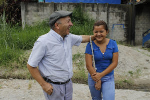 Salesian Father Jose Maria Moratalla Escudero interacts with a member of the youth orchestra he founded in a crime-ridden area of San Salvador, El Salvador. (CNS photo/Edgardo Ayala)