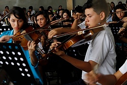Members of the youth symphony orchestra rehearse at Polígono Industrial Don Bosco, located in a crime-ridden area of San Salvador, El Salvador. (CNS photo/Edgardo Ayala) 