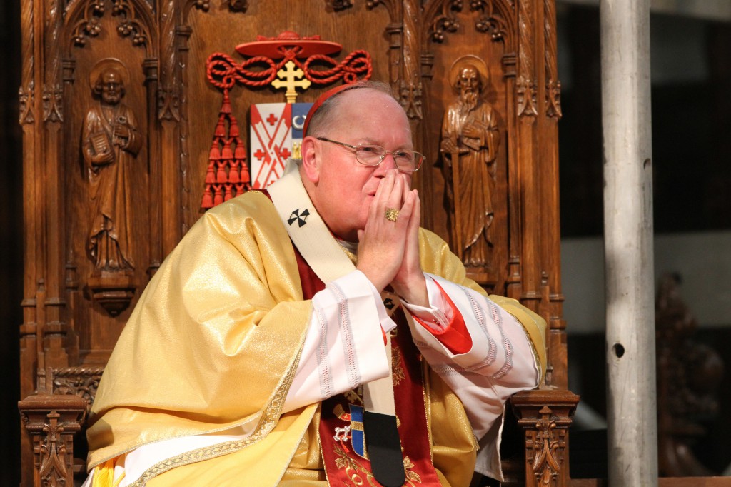 Cardinal Timothy M. Dolan of New York presides at an August Mass at St. Patrick's Cathedral in New York. The Archdiocese of New York announced it will close more than 30 by August 2015 as part of a reorganization initiative that will merge 116 parishes into 56. (CNS photo/Gregory A. Shemitz)