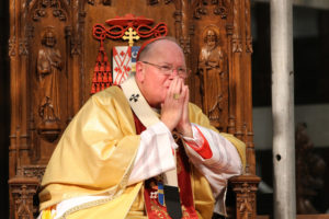 Cardinal Timothy M. Dolan of New York presides at an August Mass at St. Patrick's Cathedral in New York. The Archdiocese of New York announced it will close more than 30 by August 2015 as part of a reorganization initiative that will merge 116 parishes into 56. (CNS photo/Gregory A. Shemitz)